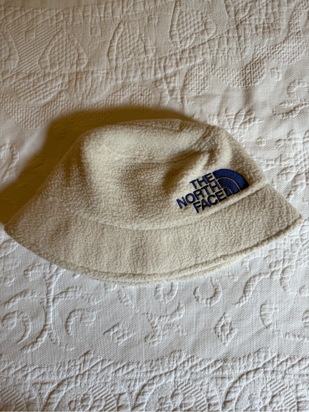 The North Face Kids Cream Fleece Bucket Hat with Navy Logo